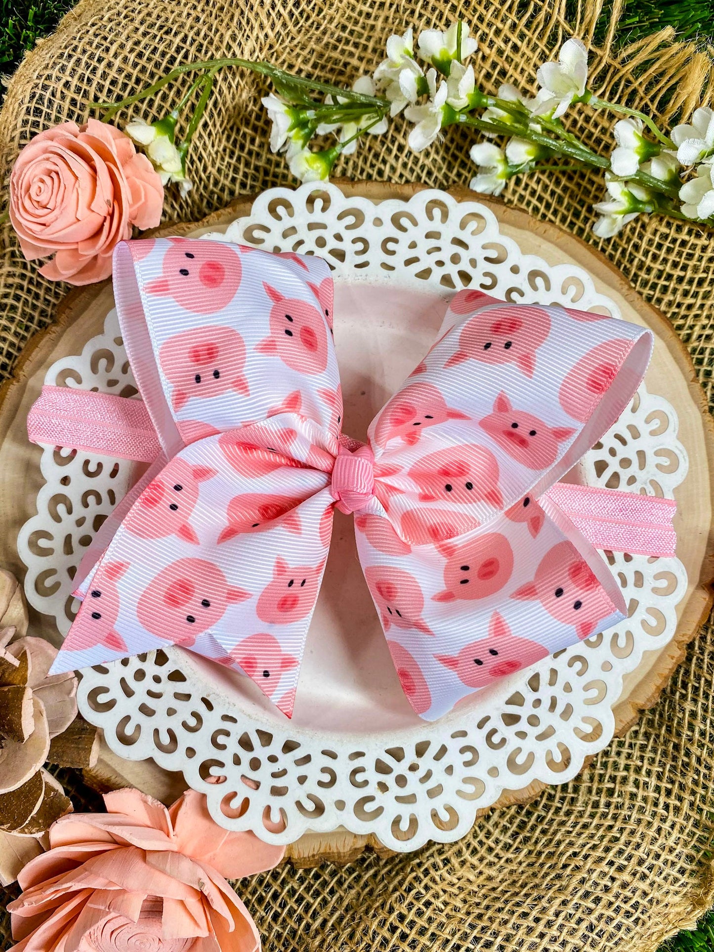 Hair bow with pink pig pattern on a headband