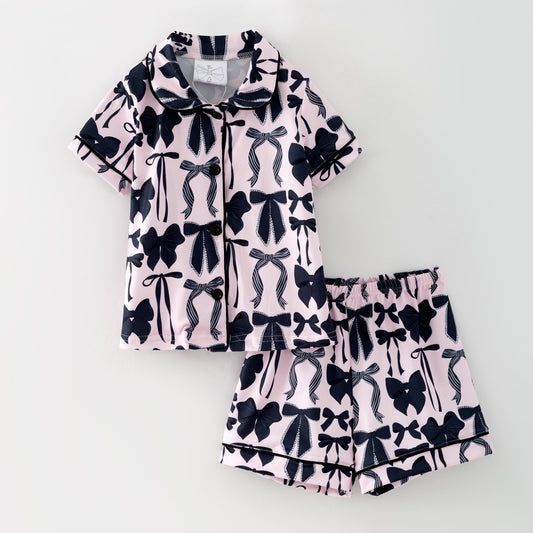 Pajama set with black bow pattern on a light pink background - Alternative view
