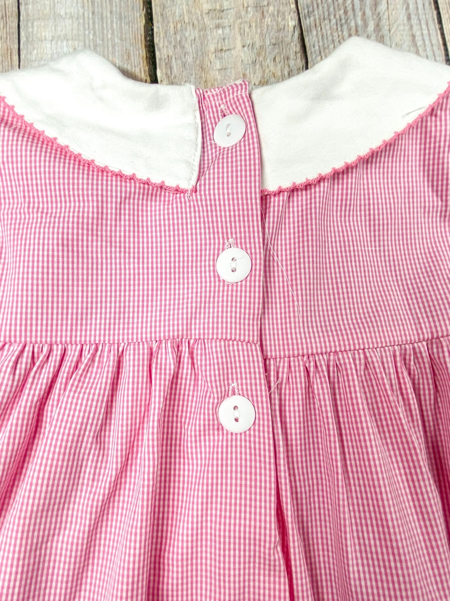 back of the dress showing 3 buttons starting from the collar and coming down