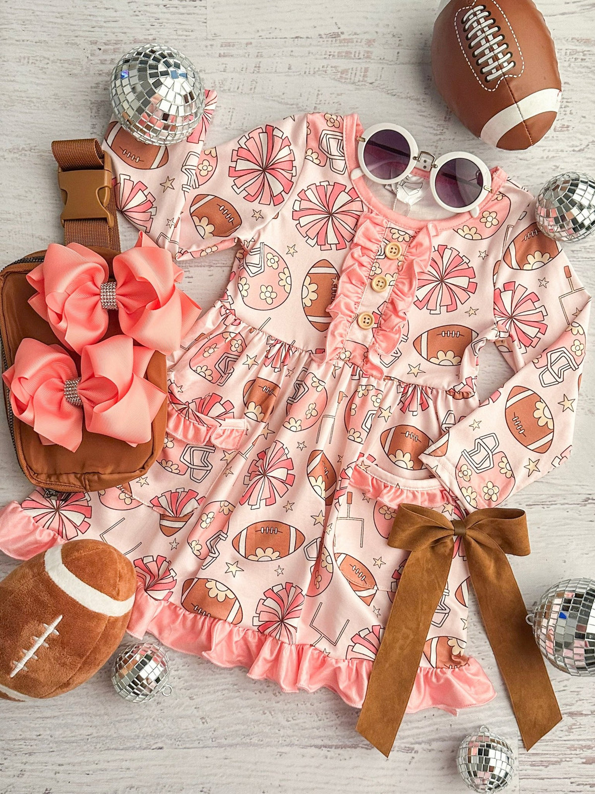 Pink twirl dress with footballs and pom poms