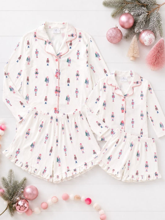 Pink Nutcracker Christmas Mommy & Me matching pajamas with pastel nutcracker print in a festive holiday flatlay. - Alternative view