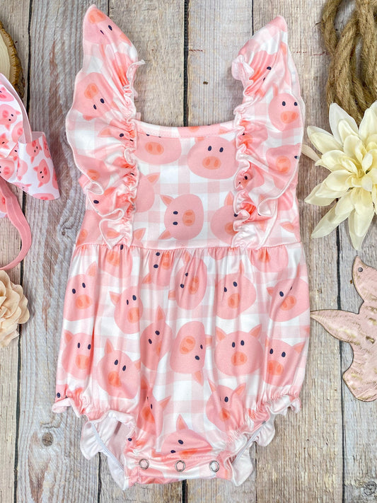 Pink romper with pig pattern on a wooden background - Alternative view