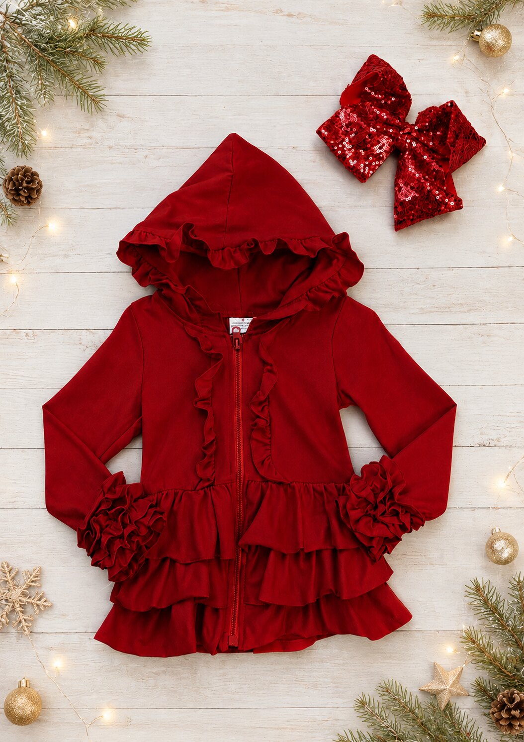 Red zip front hoodie jacket for girls with ruffles on the hood, front, and icing ruffled sleeves.