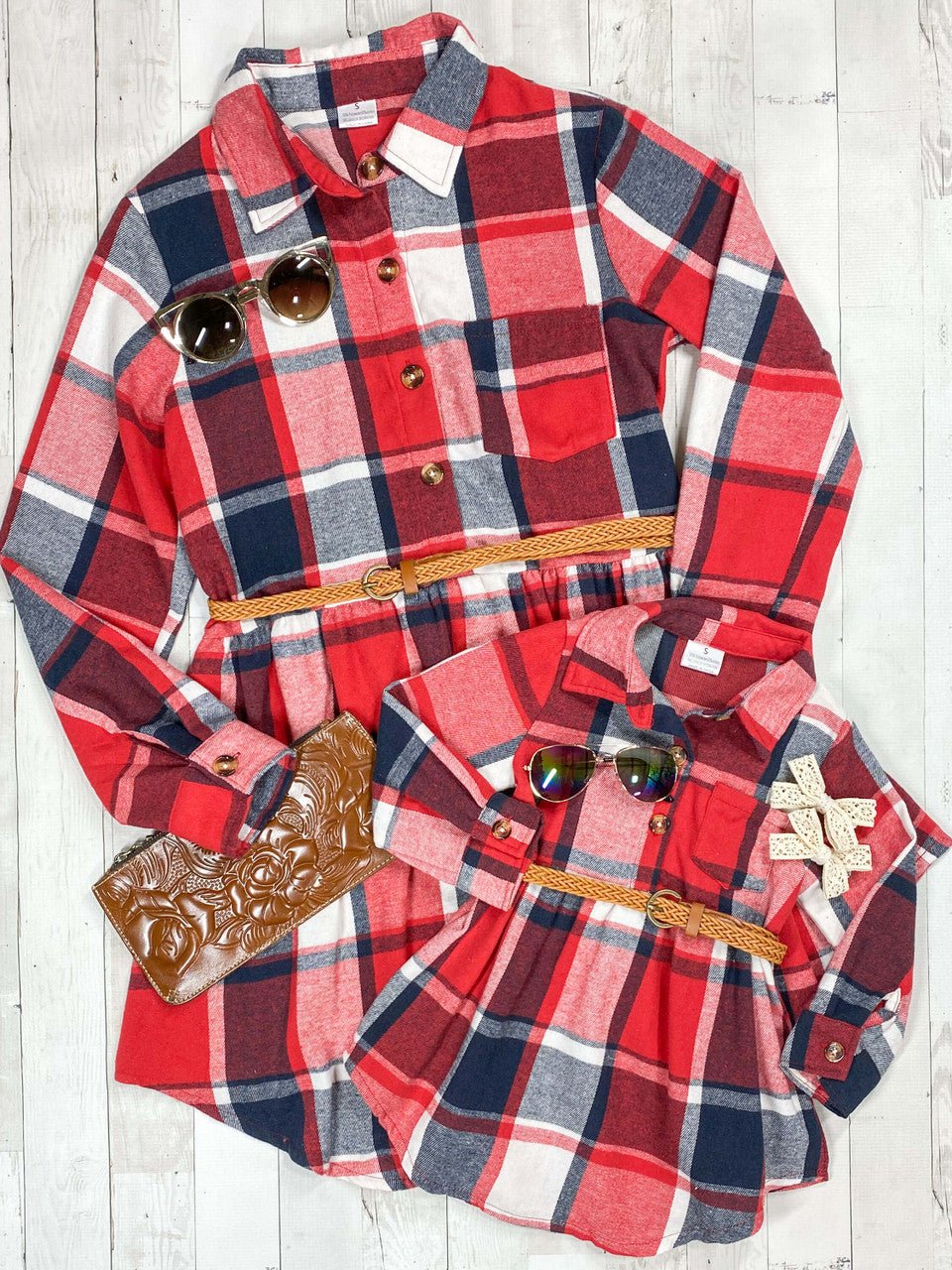 Red and blue plaid shirt with decorative elements on a wooden surface