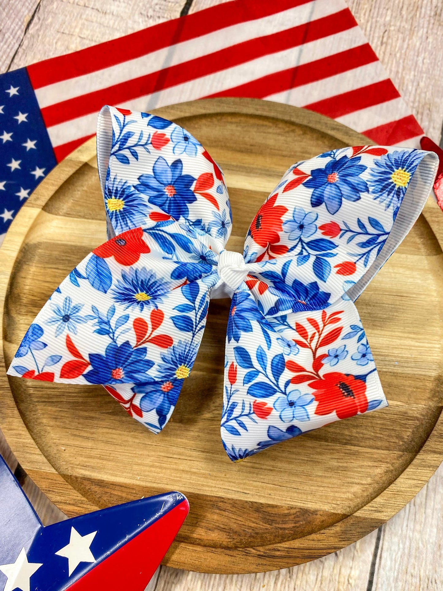 Red White & Blue Floral hairbow on a wooden background