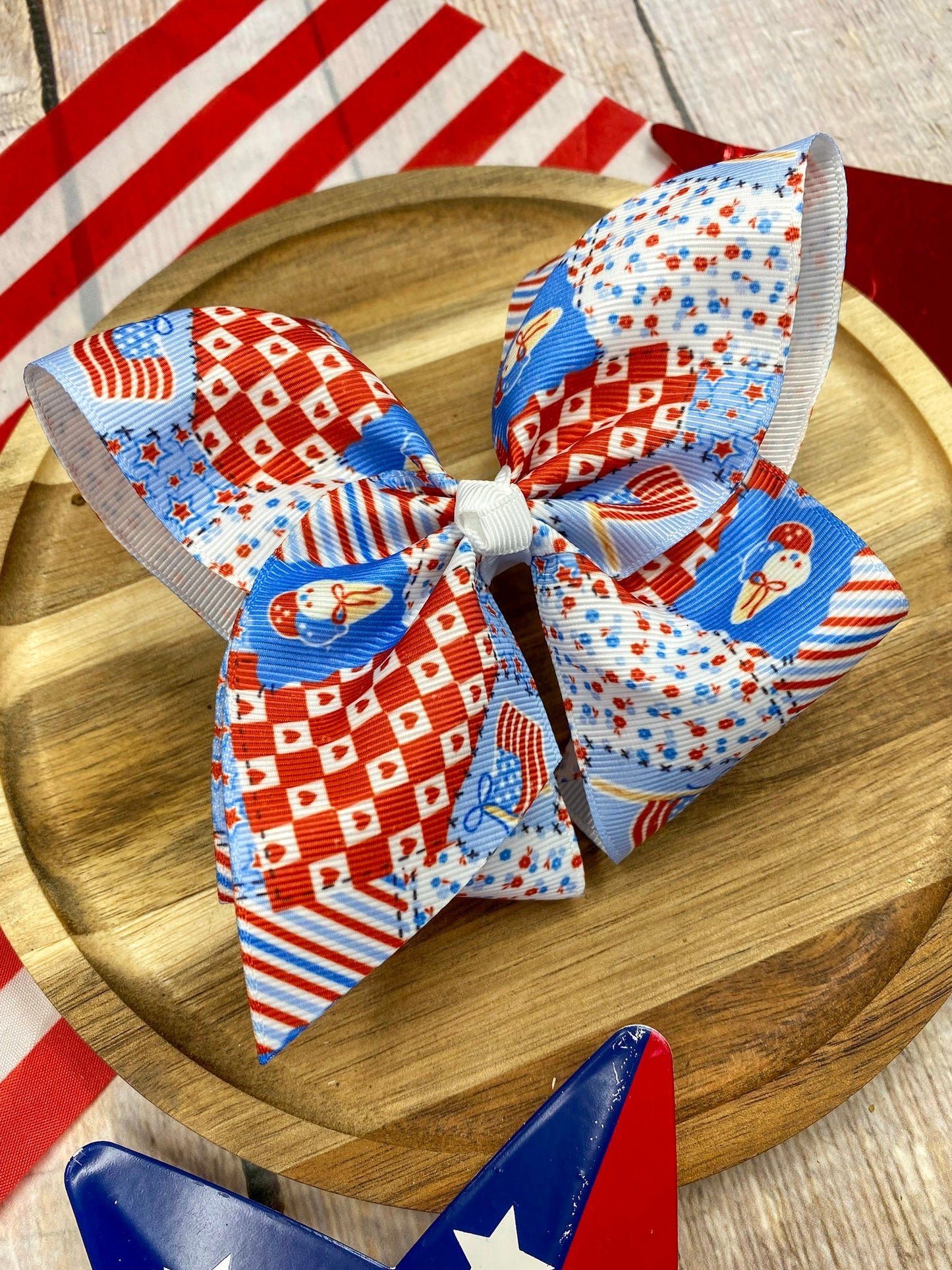 Red White & Blue Patchwork hairbow on a wooden surface