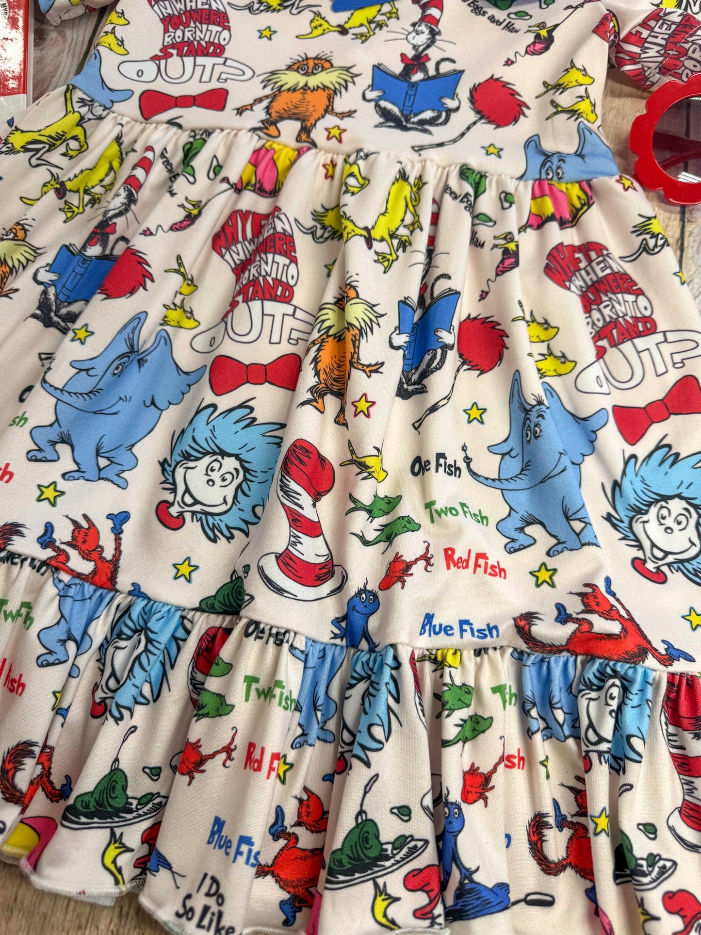 Children's dress with Dr. Seuss character print on a white background