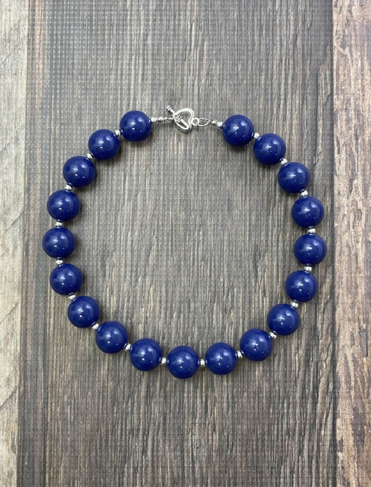 Navy chunky bead necklace on a wood table - Alternative view