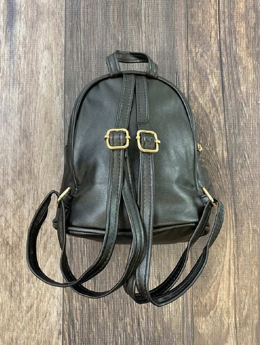 Black leather backpack with gold buckles on a wooden surface - Alternative view