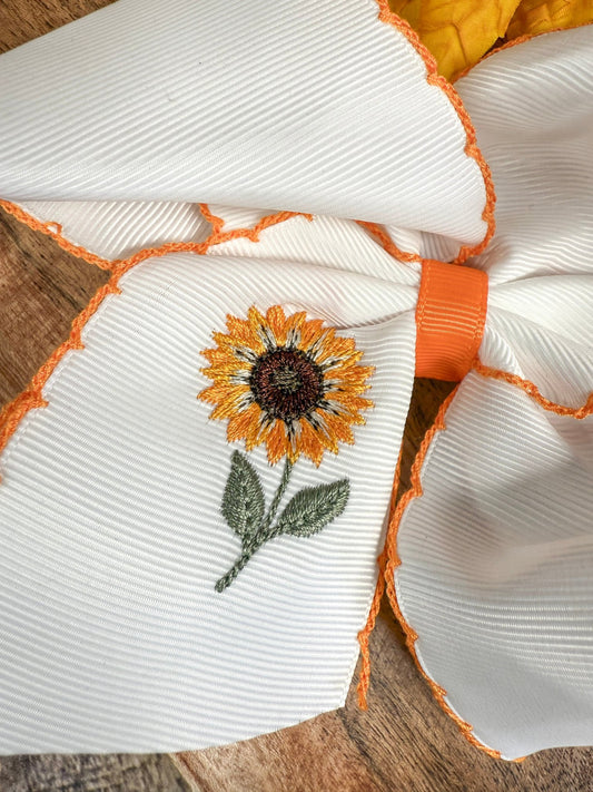 Close-up of sunflower embroidery and moonstitch detail on hair bow - Alternative view