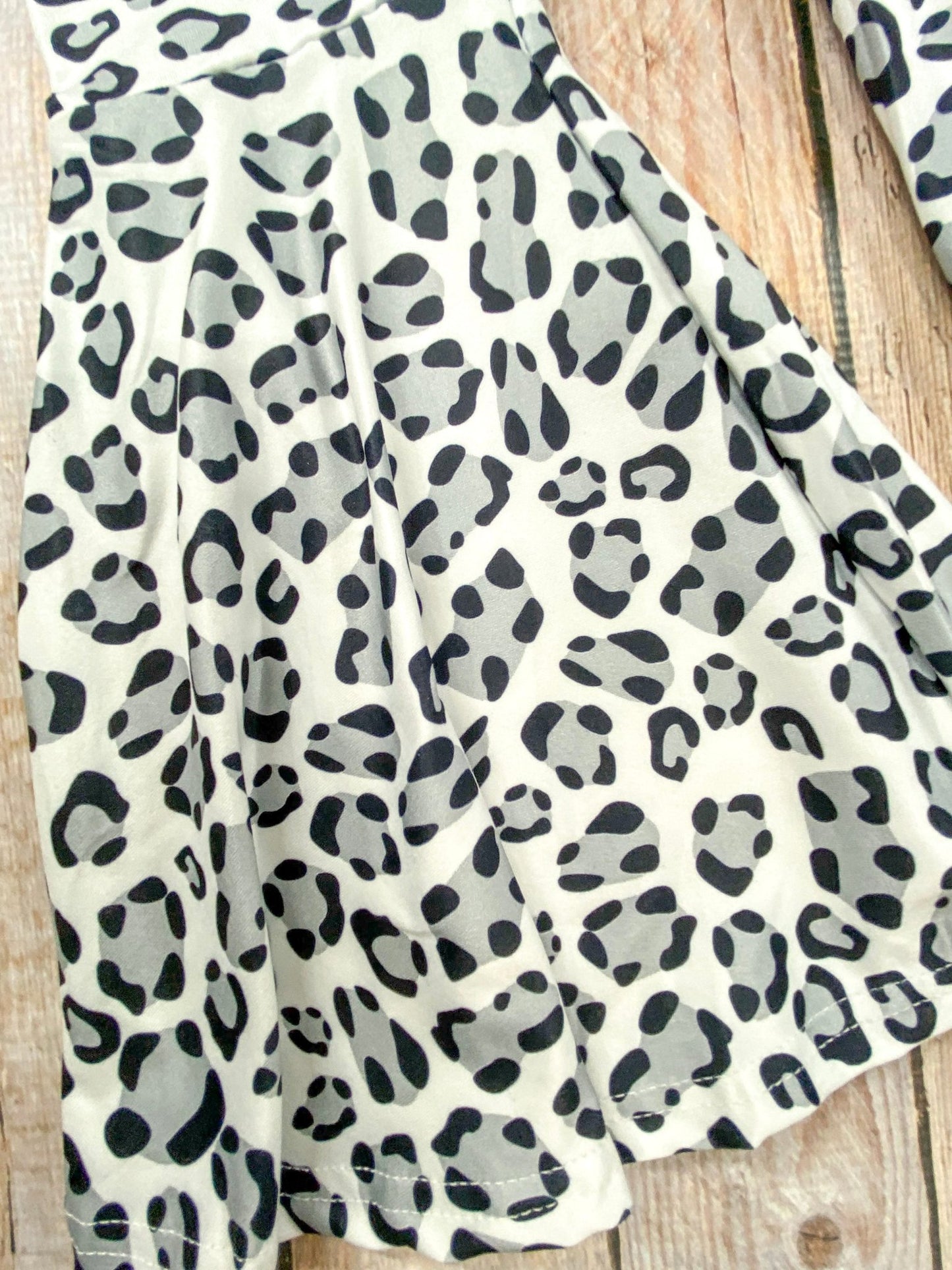 close up of the animal print on the bell bottom pants