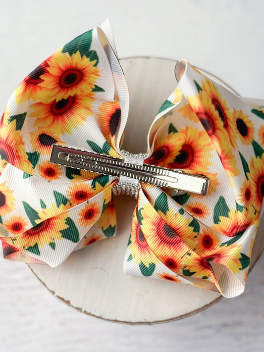Back of white sunflower Texas size hair bow showing single prong alligator clip - Alternative view