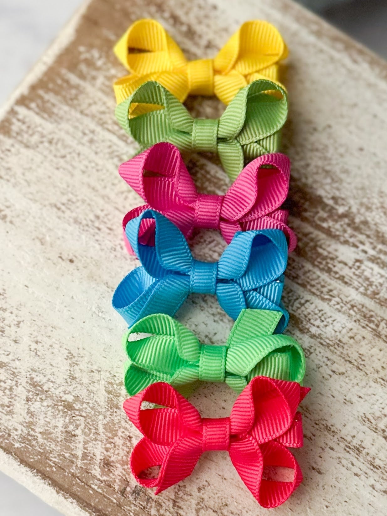 small hair bows on decorative backdrop