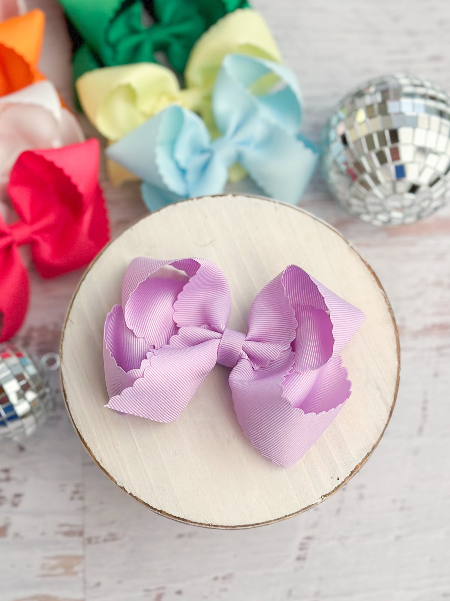 scalloped hair bows on decorative background