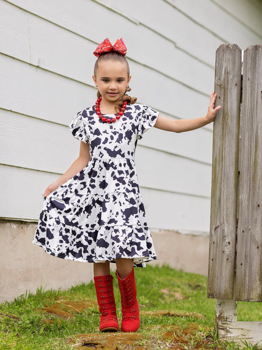 model wearing our Udderly Adorable Cow Print Twirl Dress