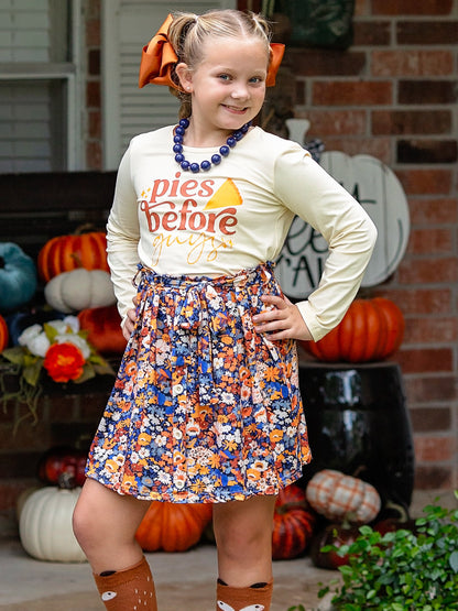 Pies before Guys skirt set for Thanksgiving on a preteen model standing on a fall front porch.