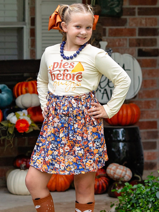 Pies before Guys skirt set for Thanksgiving on a preteen model standing on a fall front porch.