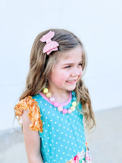 Girl wearing a 3 inch glitter hair bow
