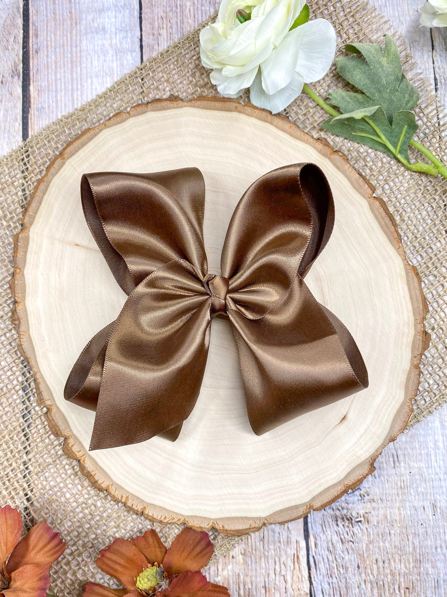 large satin brown bow on a wooden background