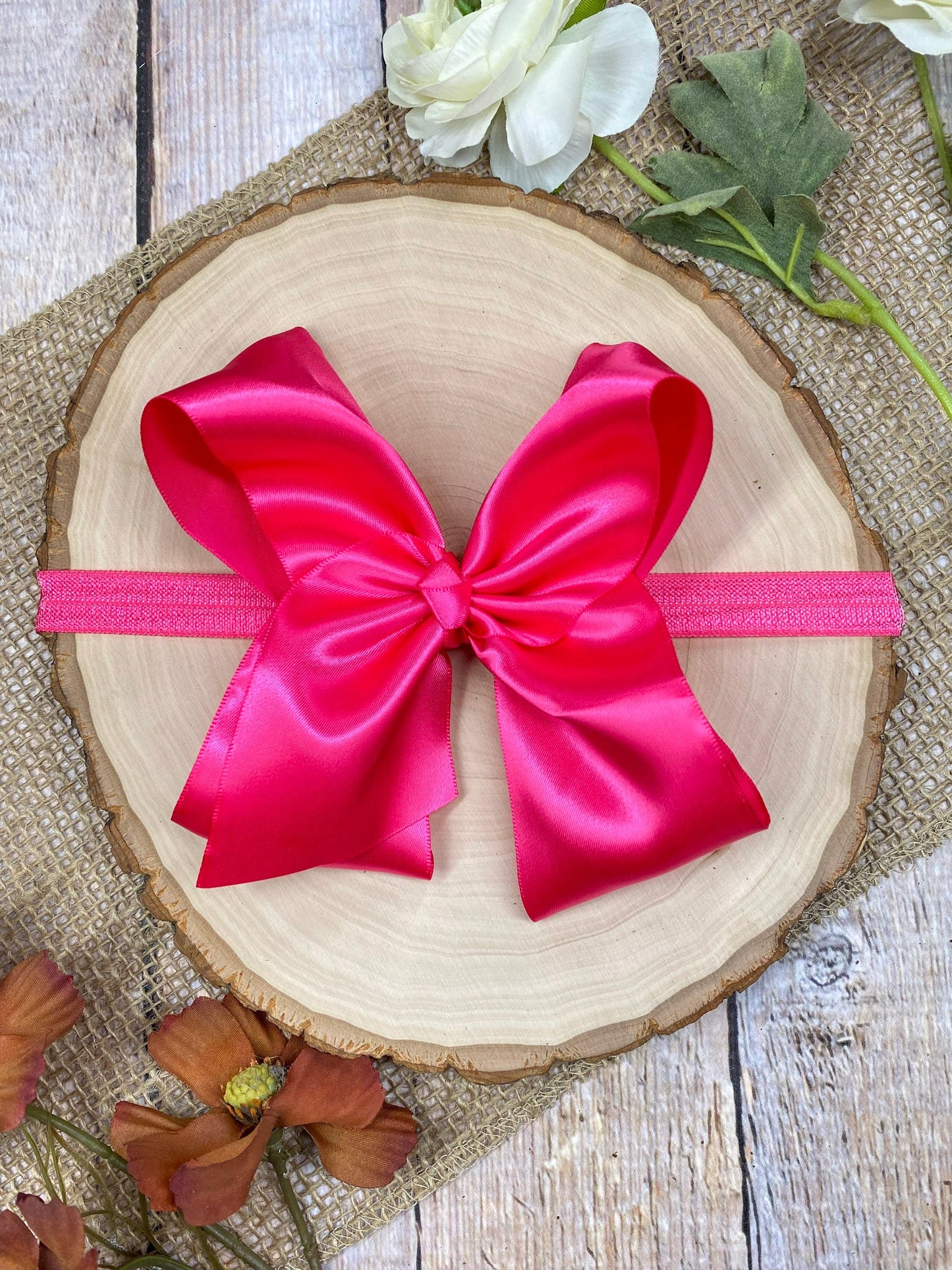 satin hot pink headband on a wooden background