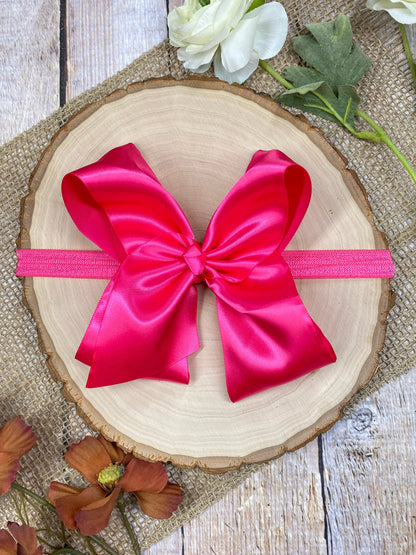 satin hot pink headband on a wooden background