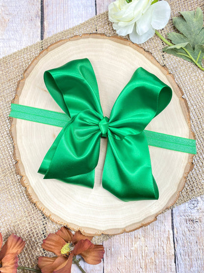 satin emerald headband on a wooden background