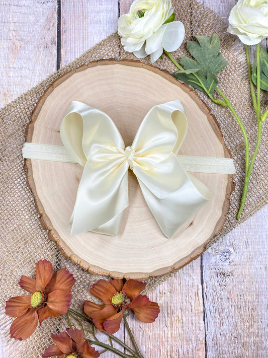 satin ivory headband on a wooden background