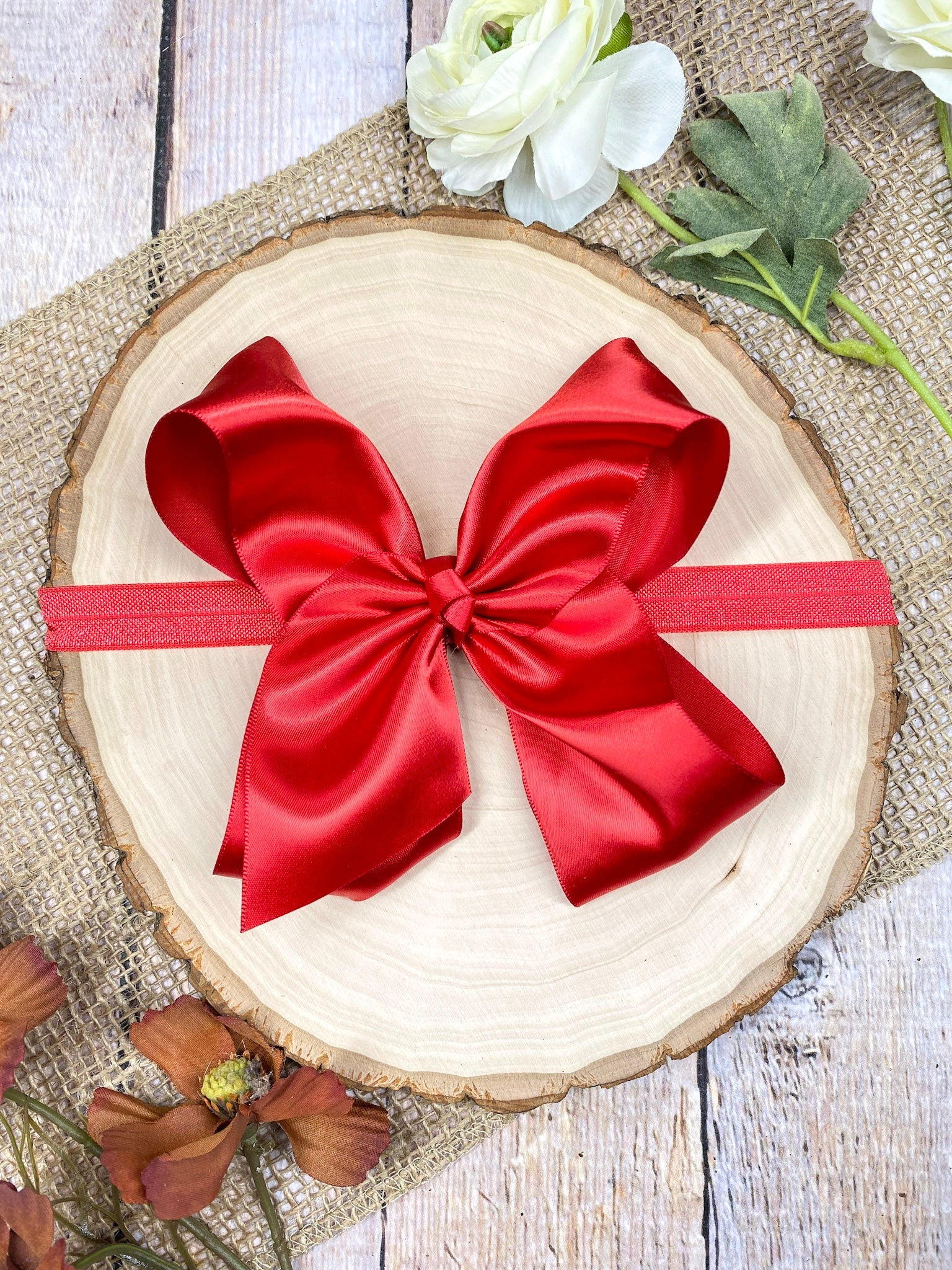 satin red headband on a wooden background