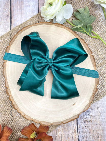 satin hunter green headband on a wooden background