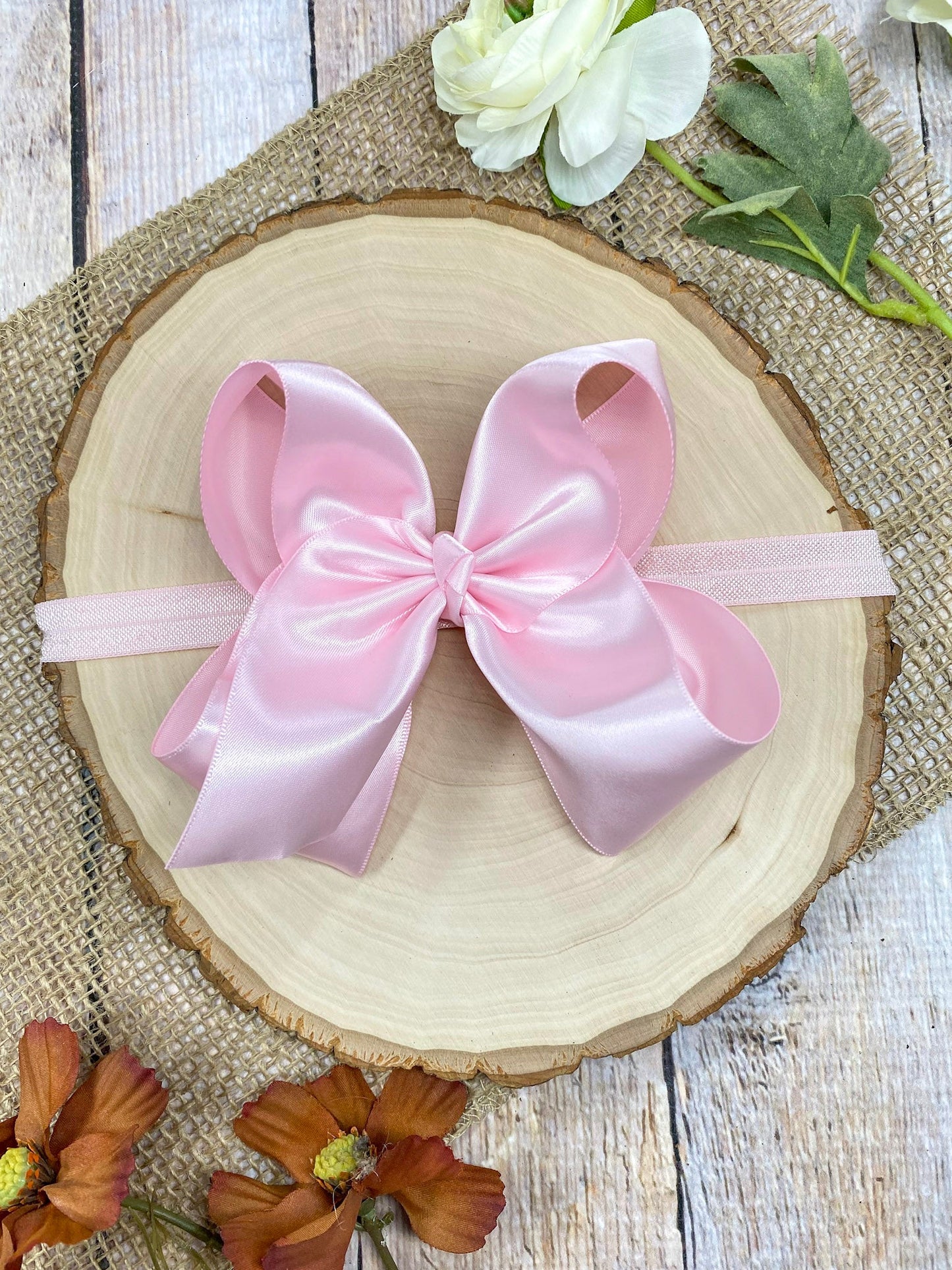 satin pinkheadband on a wooden background