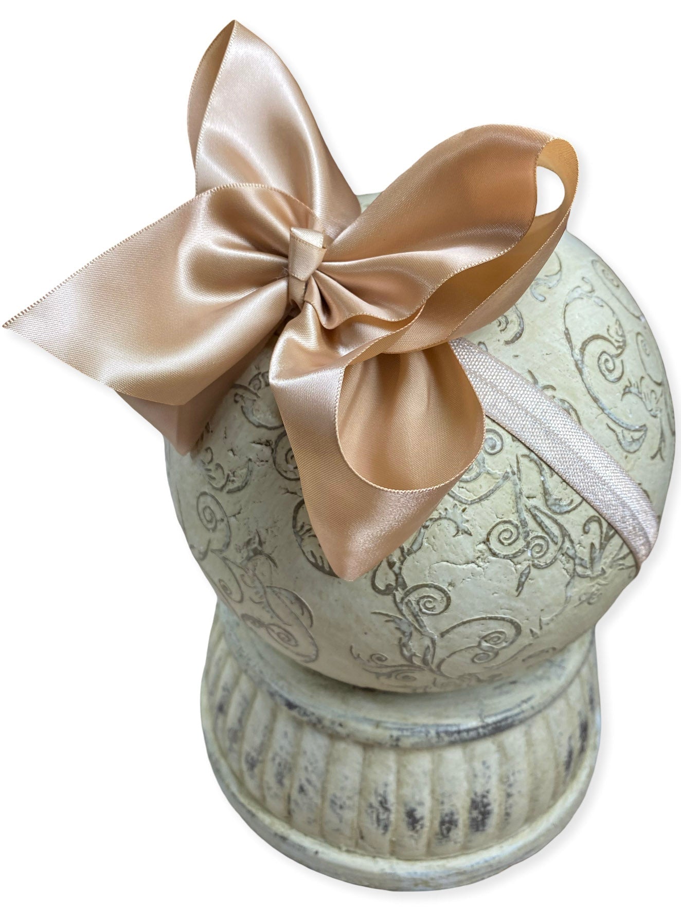 Decorative urn with a large champagne color bow on a white background