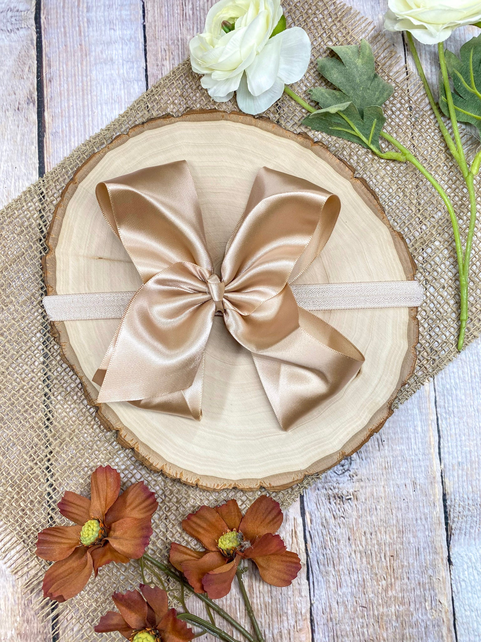 satin champagne headband on a wooden background