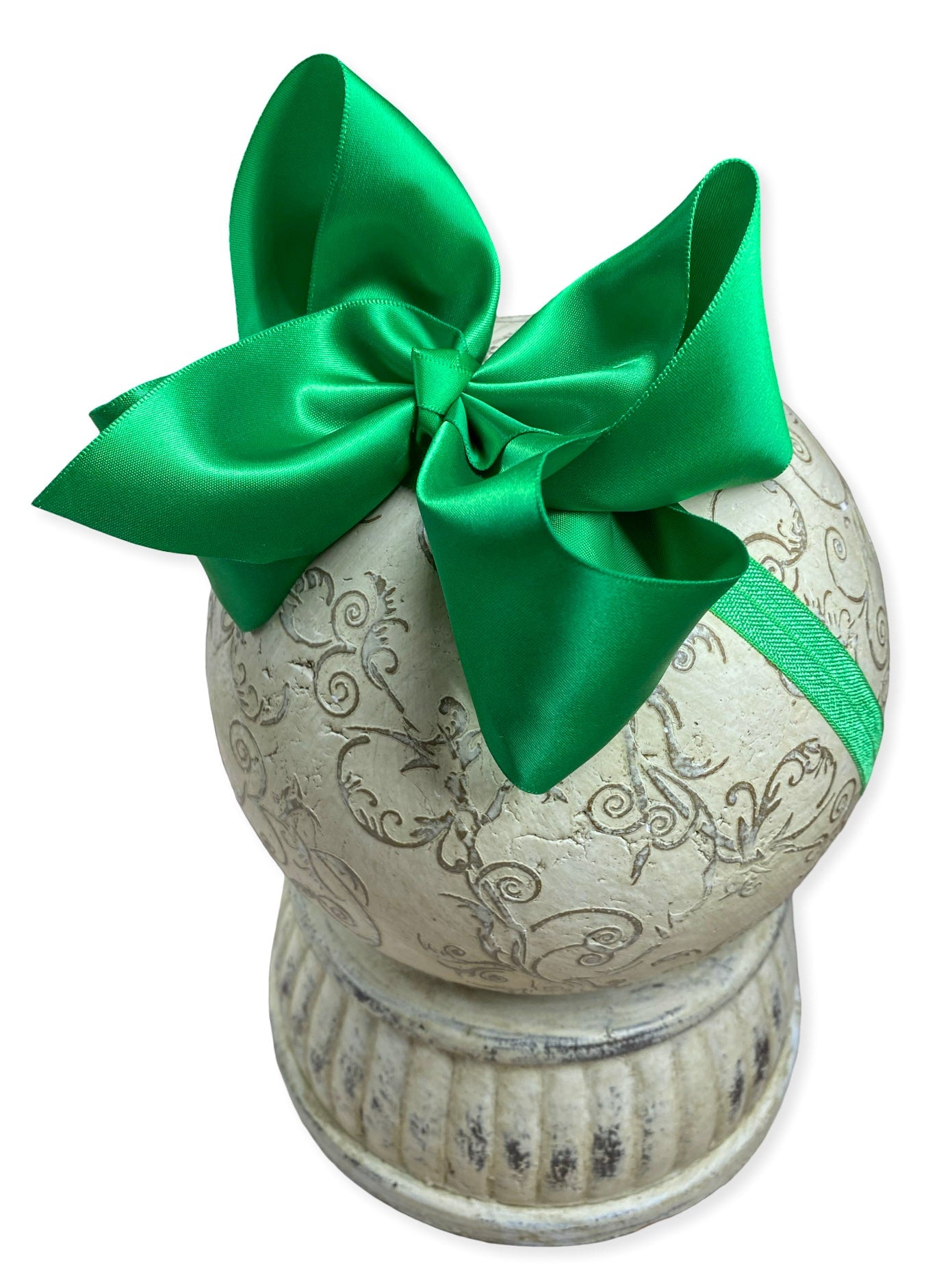 Decorative urn with a green bow on a white background
