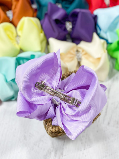 Back of a lavender 5.5 inch oversize rhinestone center knot hair bow