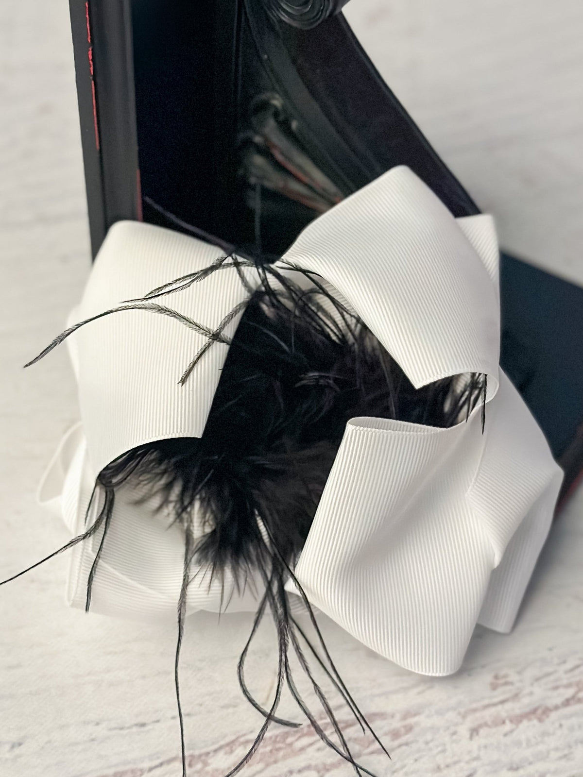 6 inch white grosgrain hair bow with black feather puff