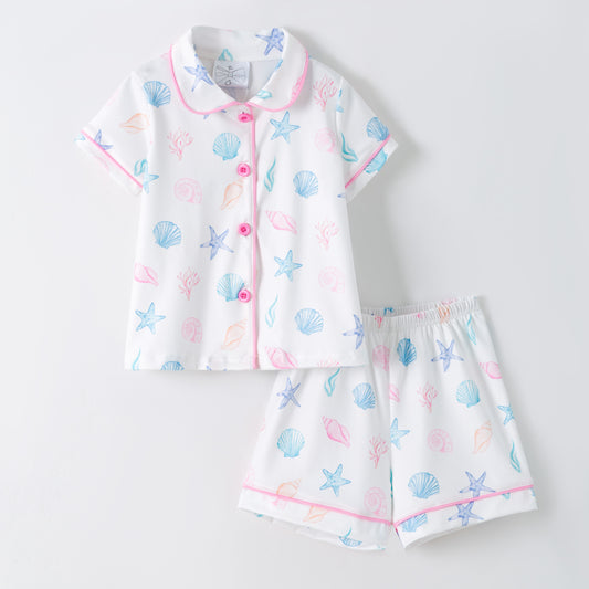 Children's pajama set with shell pattern on a light gray background