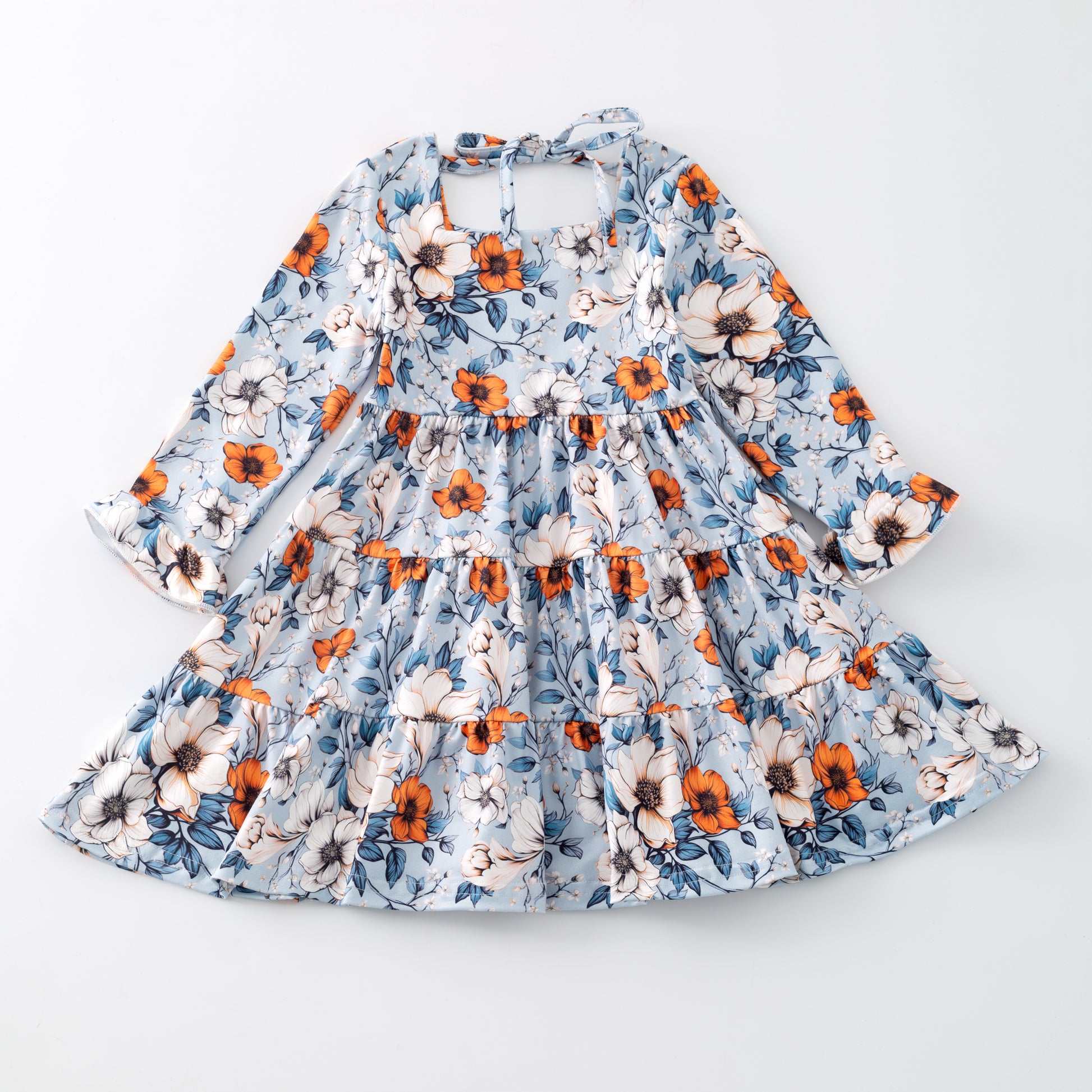 Floral dress with orange and blue pattern on a white background