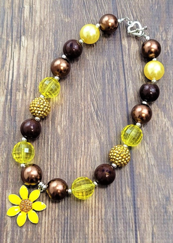 Bright sunflower pendant chunky bead necklace with a heart toggle closure.