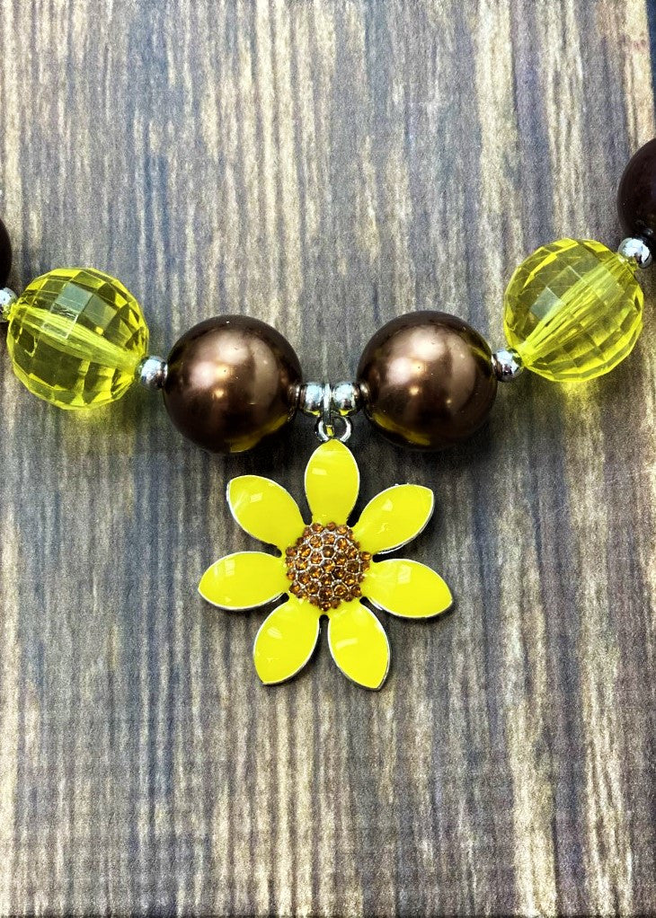 Sunflower pendant with rhinestone center.