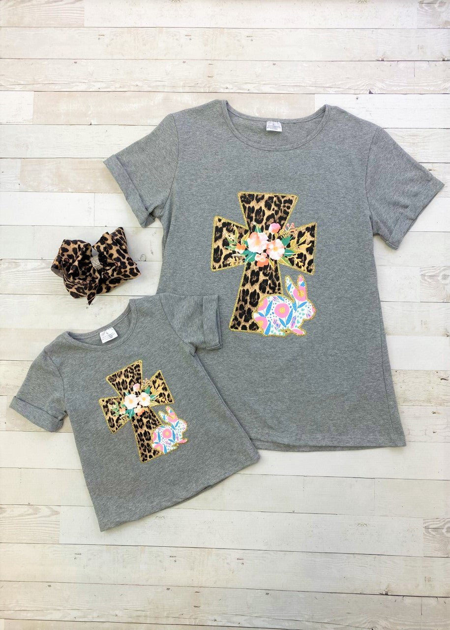 Heather grey t-shirt with rolled cuffs and a gold glitter bordered animal print cross and floral bunny. 