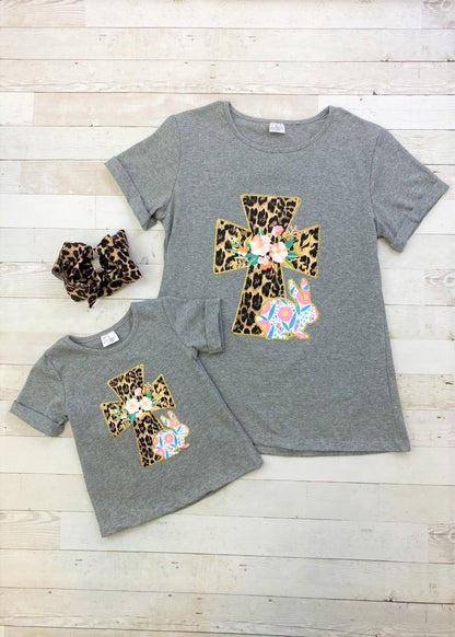 Heather grey t-shirt with rolled cuffs and a gold glitter bordered animal print cross and floral bunny. 