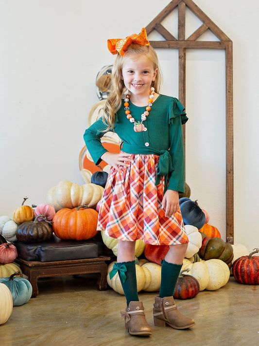 Green and plaid ruffle twirl dress on model.
