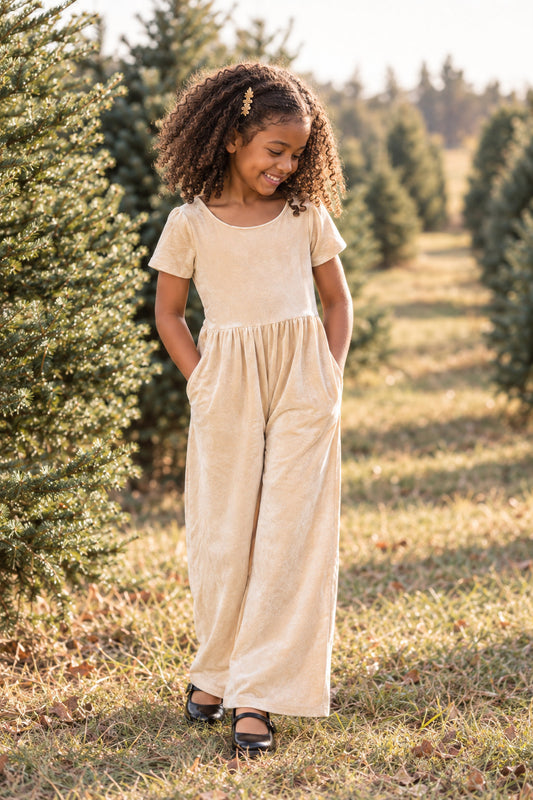 model wearing our cream velvet romper at a christmas tree farm