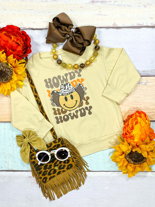 Long sleeve shirt with Howdy and a smily face under a cowgirl hat.
