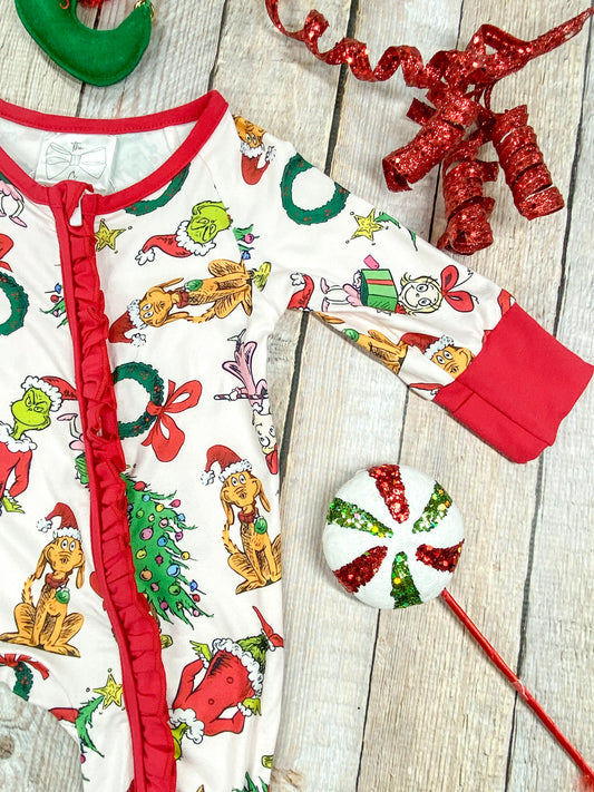 Detailed close-up of white knit fabric on infant romper, showcasing colorful Grinch-themed holiday print including characters like the Grinch, Max the dog, Cindy Lou Who, wreaths, red bows, ornaments, and decorated Christmas trees. Zoomed-in photo of the bright red ribbed knit cuff on the romper’s sleeve, designed for a snug and cozy fit on baby’s wrist. - Alternative view