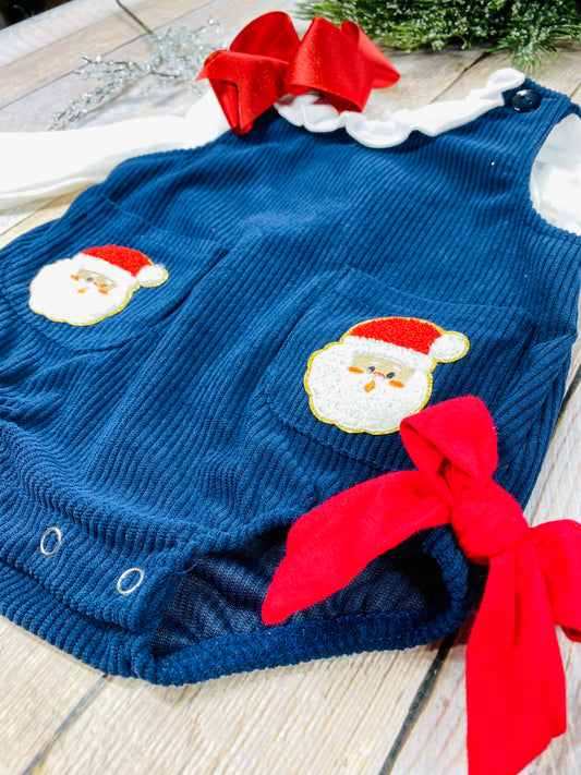 Infant girls’ navy blue corduroy romper with long white puff sleeves, red grosgrain bows at the hips, and front patch pockets with embroidered Santa Claus appliqués. Snap closure at the bottom for easy changes. - Alternative view