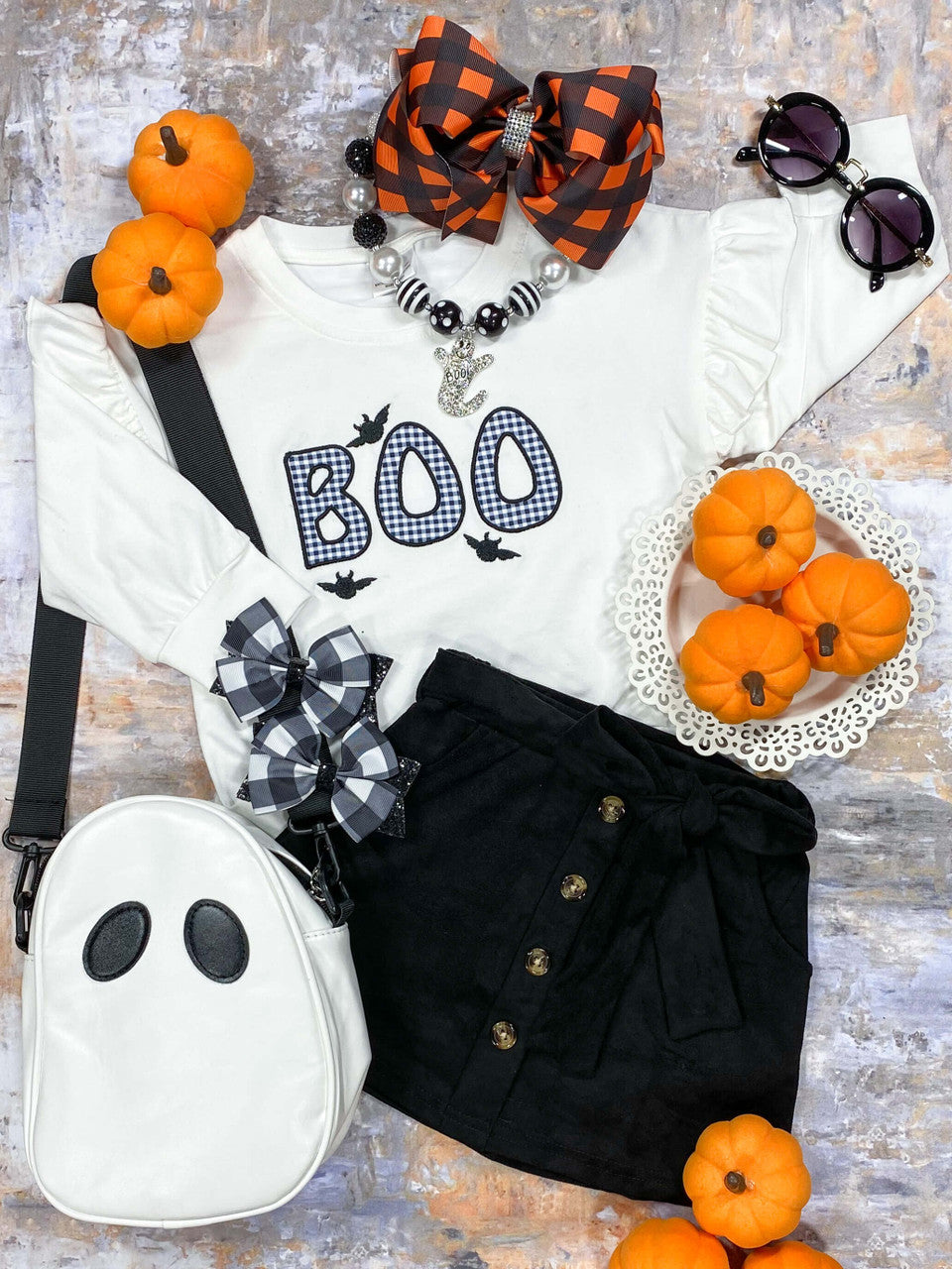 White long sleeve 'Boo' appliquéd top with black court skirt.