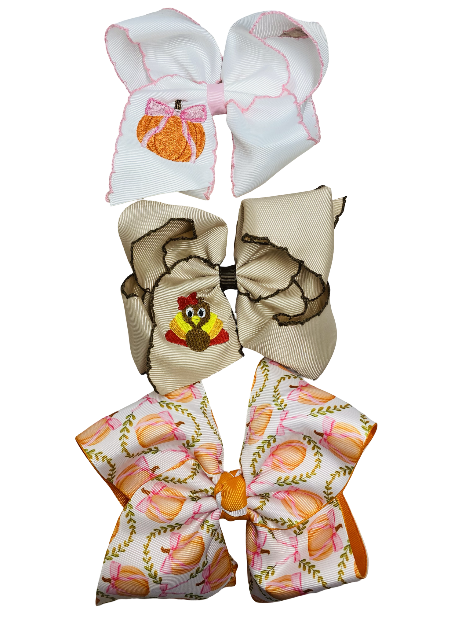 Three decorative bows with different fall patterns on a white background