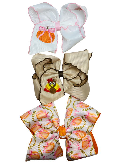 Three decorative bows with different fall patterns on a white background - Alternative view