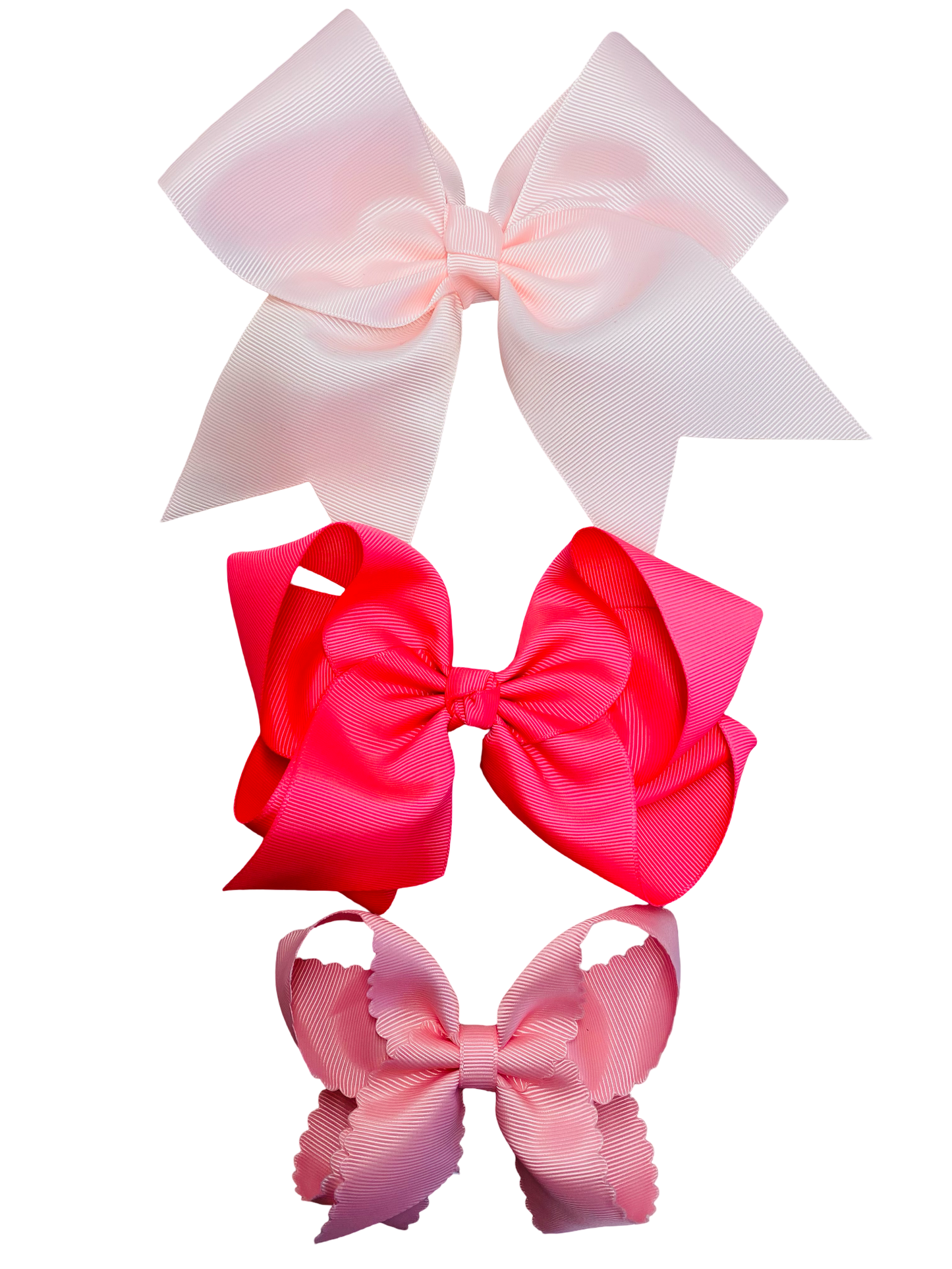 Three large hair bows in pinks on a white background